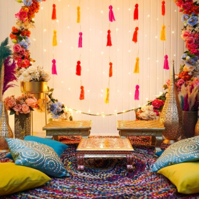 Relaxed boho Mehndi ceremony lounge decor with floral accents by Pranaya Weddings Chennai
