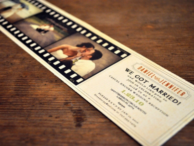 An elegantly designed wedding invitation with a strip showcases the concept of film-type weddings.